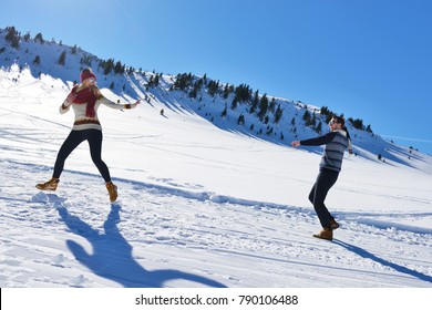 Couple having fun running down slope