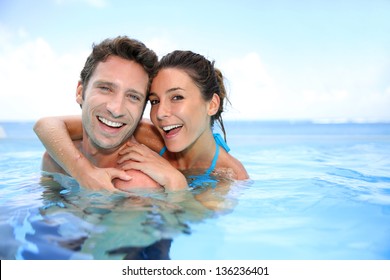 Couple having fun in swimming-pool - Powered by Shutterstock