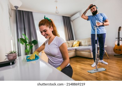 Couple Having Fun While Doing Spring Cleaning Together