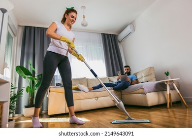 Couple Having Fun While Doing Spring Cleaning Together