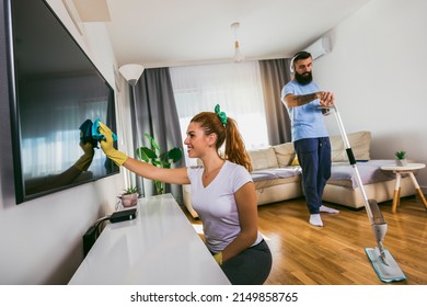 Couple Having Fun While Doing Spring Cleaning Together