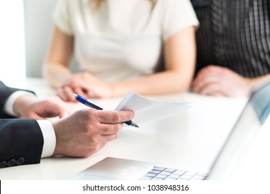 Couple Having Meeting With Legal Advisor, Real Estate Agent, Businessman Or Banker. Lawyer Giving Advice Or Consultant Showing Document Or Agreement To Man And Woman. Insurance Or Car Leasing Paper.
