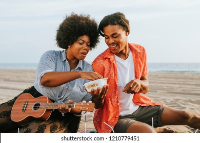 Couple Having A Picnic At The Beach