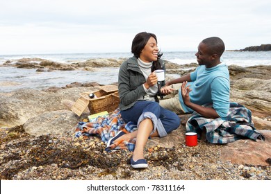 Couple Having Picnic On Beach