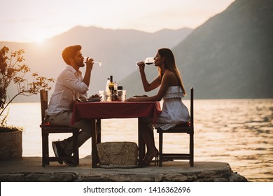 Couple Is Having A Private Event Dinner On A Tropical Beach During Sunset Time