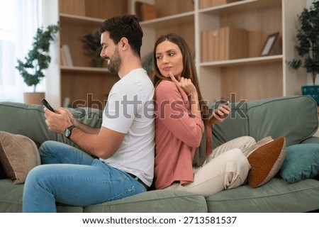 Couple having relationship problems, one partner spying on phone, feeling jealousy