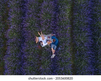 Couple Having Romantic Date Picnic At Lavender Field Overhead Top View