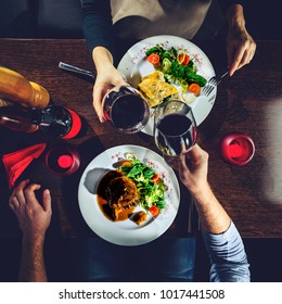 Couple having romantic dinner in a restaurant, toned image