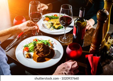 Couple Having Romantic Dinner In A Restaurant In Rays Of The Sun