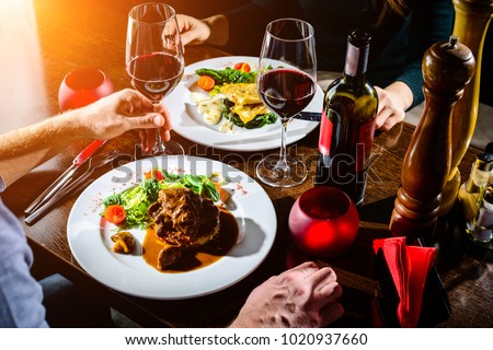 Couple having romantic dinner in a restaurant in rays of the sun