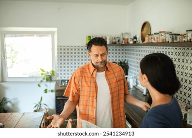 Couple having a serious conversation in the kitchen - Powered by Shutterstock