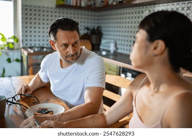 Couple having a serious conversation in the kitchen - Powered by Shutterstock