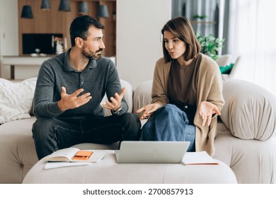 Couple having a serious conversation while looking at online documents for budgeting