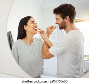 Couple health, dental cleaning and interracial people in bathroom, brushing teeth and healthy tooth care in home. Happy, smile and love man and woman in happiness with oral wellness in morning - Powered by Shutterstock