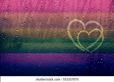 Couple Of Heart Shape Drawn On Glass Window With Rainbow Gradient Color And Droplet, Gay And Homosexual Love Concept