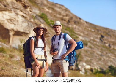 Couple hikers with backpack on hike in nature - Shutterstock ID 1702494991