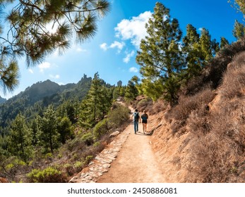 A couple of hikers on the trail up to Roque Nublo in Gran Canaria, Canary Islands - Powered by Shutterstock