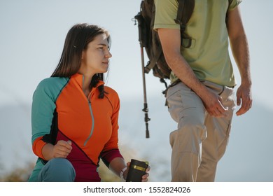 Couple Hikers Taking A Break On The Mountaintop