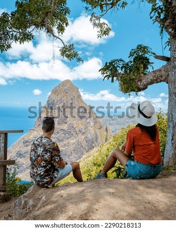 couple hiking in mountains Saint Lucia Caribbean, nature trail in jungle with view of huge Pitons of St Lucia