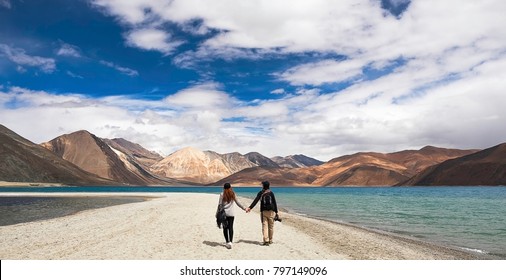 Couple hold hand together , Very nice sky and mountain , at Pangong lake , Ladakh , India - Powered by Shutterstock