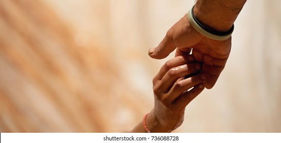 Couple hold hands,help when overcoming hindrances mud and water - Shutterstock ID 736088728