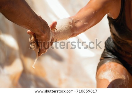 Couple hold hands,help when overcoming hindrances mud race runners
