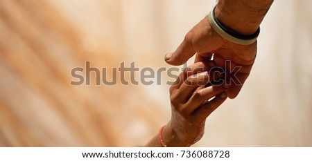 Couple hold hands,help when overcoming hindrances mud and water