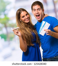 Couple Holding Boarding Pass, Outdoor