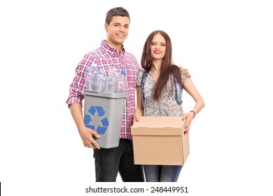 Couple holding a box and a recycle bin isolated on white background - Powered by Shutterstock