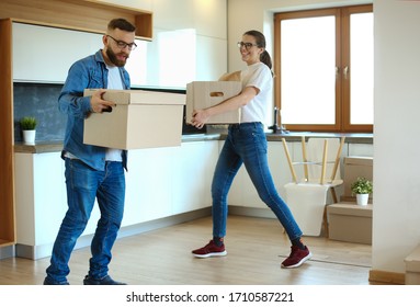 Couple holding boxes for moving the hands and have a dance with boxes