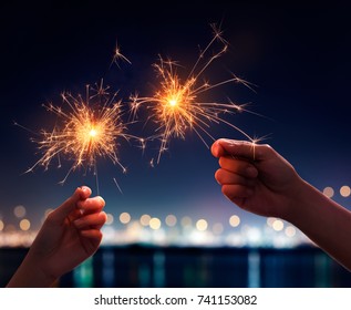 Couple holding a burning sparklers