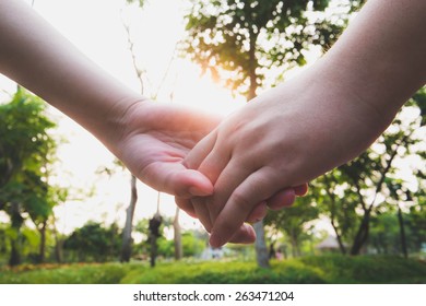 couple holding hand in sunset