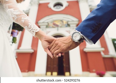 couple holding hands at church entrance - Powered by Shutterstock