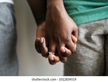Couple holding hands closeup