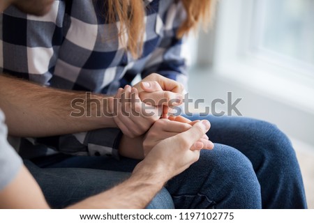 Couple holding hands, consoling, showing love and empathy close up. Husband support, understanding, care wife. Overcoming problems, saying sorry, good relationships