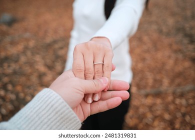 Couple holding hands with a engagement ring on the bride finger. POV shot of proposal scene is romantic and intimate - Powered by Shutterstock