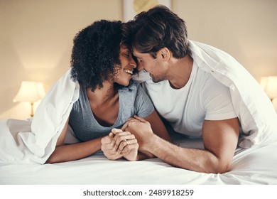 Couple, holding hands and kiss on bed in morning for love, support and respect in apartment. Happy man, woman and together in home for smile, care and trust or relax and cuddle on weekend in house - Powered by Shutterstock