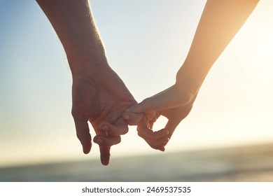 Couple, holding hands and little finger at beach in close up with bonding, love and connection on vacation. People, partner and sunset for trust, care and pinky promise by sea on holiday in Greece - Powered by Shutterstock
