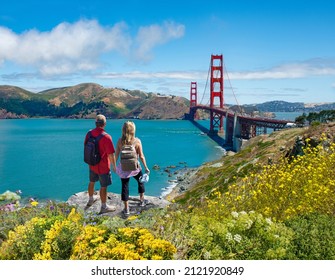 Couple holding hands looking at beautiful coastal landscape. Couple enjoying beautiful scenery on vacation. Golden Gate Bridge, San Francisco Bay, San Francisco, California, USA. - Powered by Shutterstock