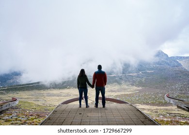 Couple holding hands on an abandoned cableway platform building social distancing beautiful landscape in Serra da Estrela, Portugal - Powered by Shutterstock