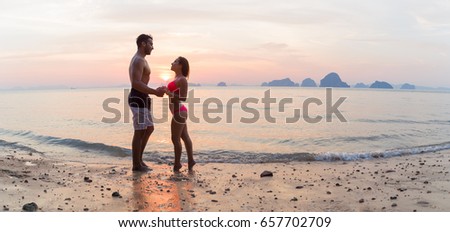 Couple Holding Hands On Beach At Sunset, Young Tourist Man And Woman On Sea Holiday While Summer Vacation
