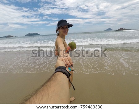 Couple Holding Hands on the Beach