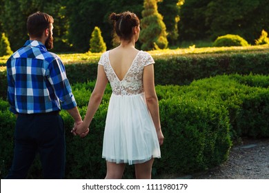 Couple Holding Hands Walking Away