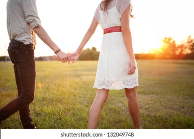 Couple Holding Hands Walking Away