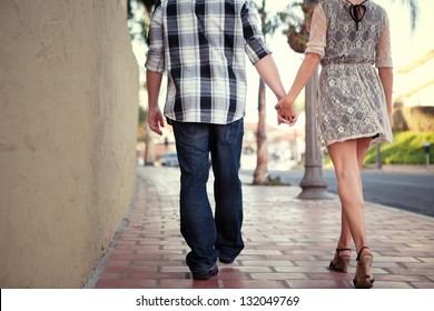 Couple Holding Hands Walking Away