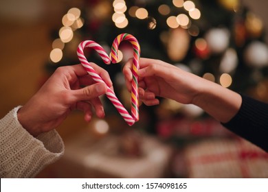 Couple holding Heart Shape Candy Cane - Powered by Shutterstock