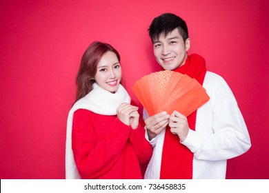 Couple Holding Red Envelope On The Red Background