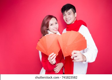 Couple Holding Red Envelope On The Red Background