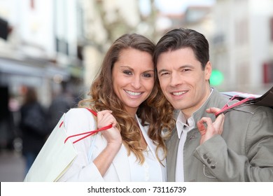 Couple Holding Shopping Bags In Town