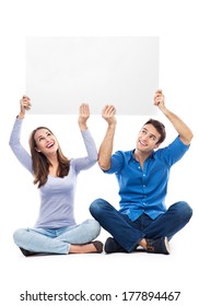 Couple Holding Sign Above Their Heads 